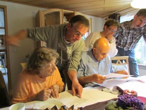 Clients of European Focus Private Tours Ken and Gloria Temple go over family ancestry with cousins in Eissen, Germany during their private tour in September, 2013